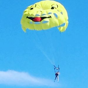 a smiley face parachute over the Mediterranean