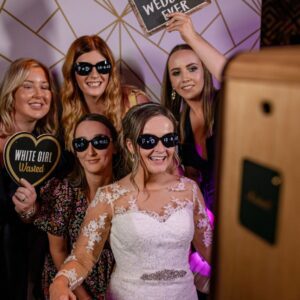 bride and friends enjoying a fantastic wedding photo booth