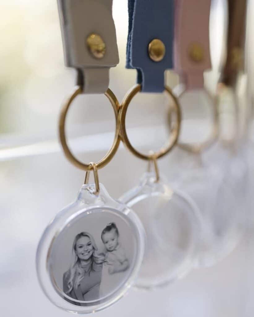 Close up of photo booth keyring wedding favours with gold details and leather straps
