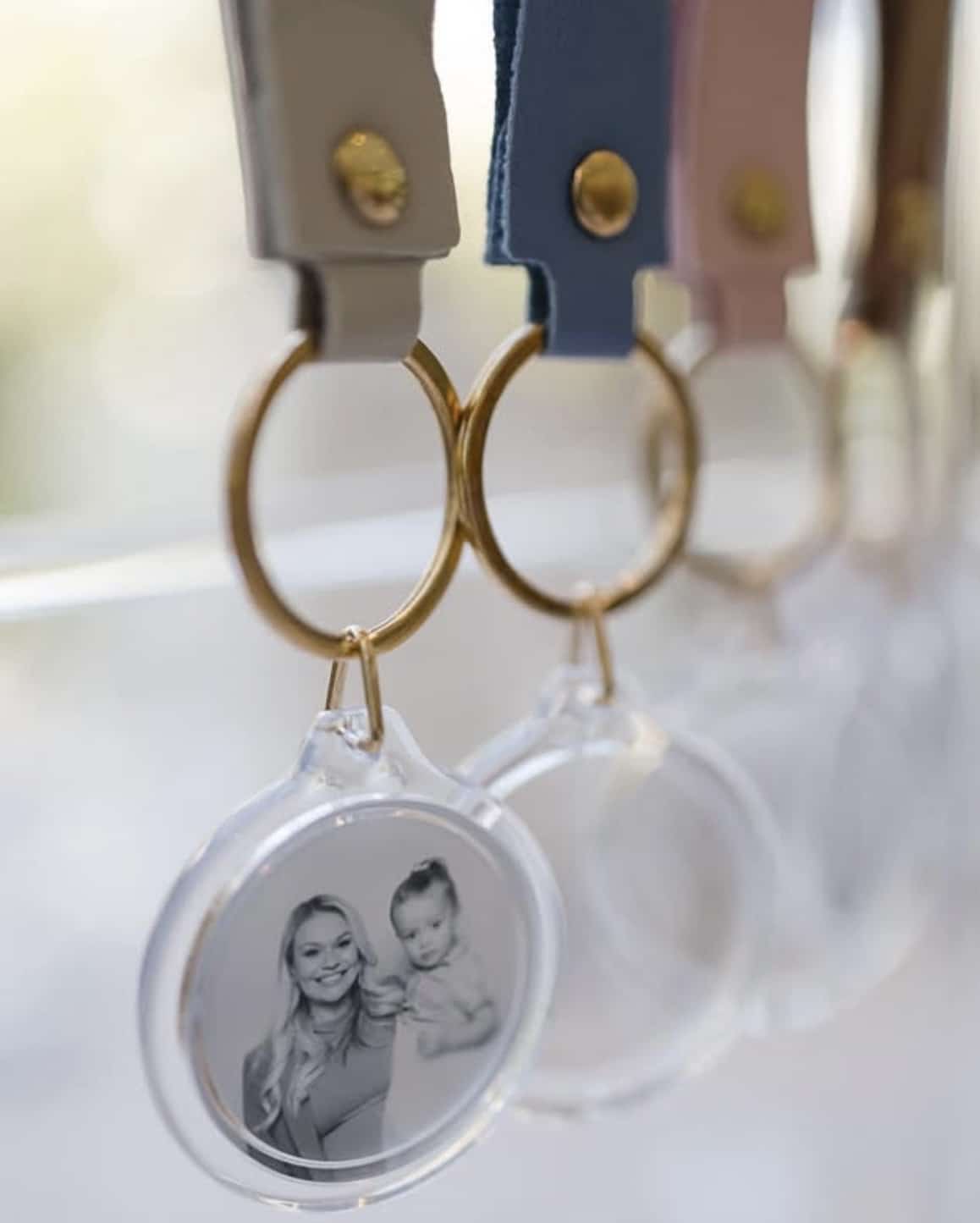 Close up of photo booth keyring wedding favours with gold details and leather straps